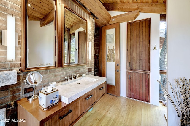 bathroom with vanity, hardwood / wood-style floors, vaulted ceiling with beams, and wooden ceiling