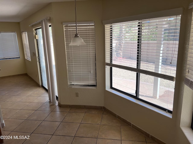 unfurnished dining area with tile patterned floors and a healthy amount of sunlight