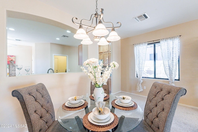 dining area featuring a chandelier, carpet floors, visible vents, and recessed lighting