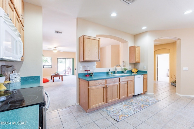 kitchen featuring light brown cabinets, ceiling fan, sink, light colored carpet, and white appliances