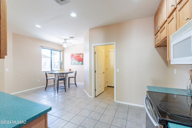 kitchen featuring a ceiling fan, light tile patterned flooring, stainless steel electric range oven, white microwave, and recessed lighting