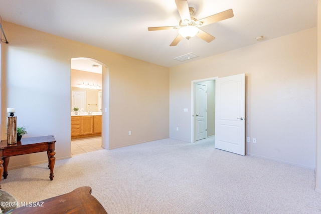 carpeted bedroom with connected bathroom and ceiling fan