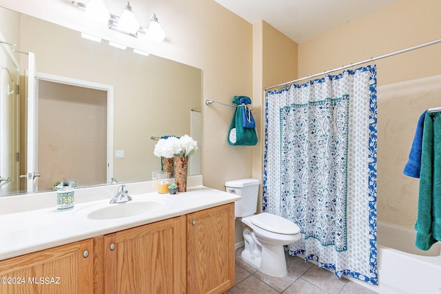full bathroom with shower / tub combo with curtain, vanity, tile patterned flooring, and toilet