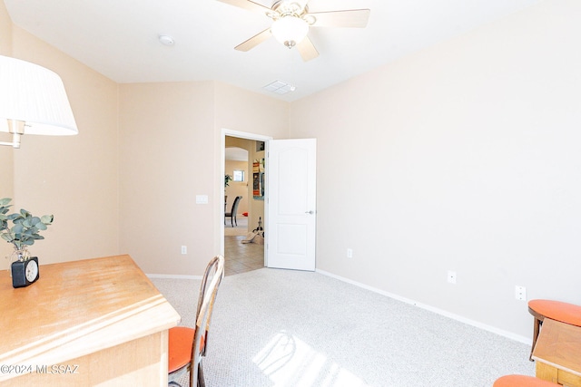 office space with baseboards, visible vents, light colored carpet, and ceiling fan
