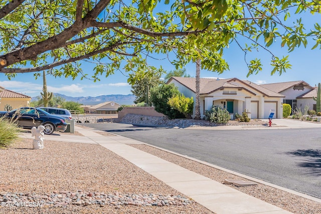 view of road with sidewalks and a mountain view
