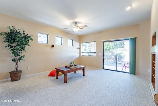 unfurnished living room with a ceiling fan, carpet flooring, and a healthy amount of sunlight