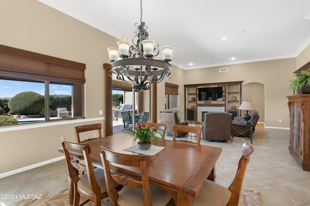 tiled dining space featuring crown molding and a notable chandelier