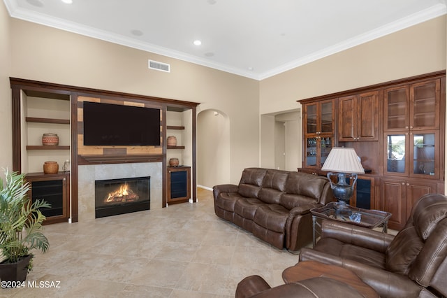 living room featuring ornamental molding and a fireplace