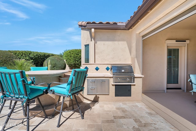 view of patio featuring exterior kitchen and grilling area