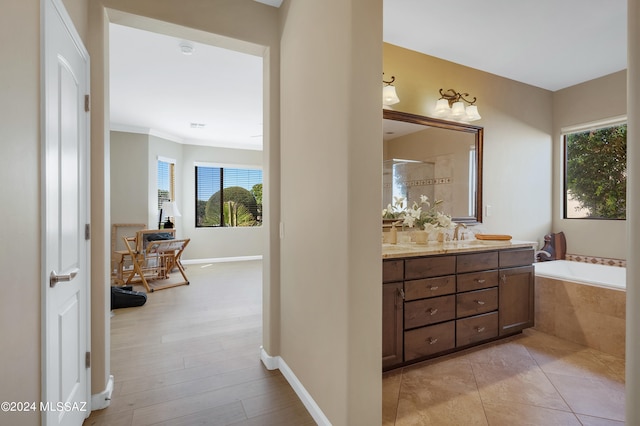 bathroom with vanity, crown molding, plus walk in shower, and plenty of natural light