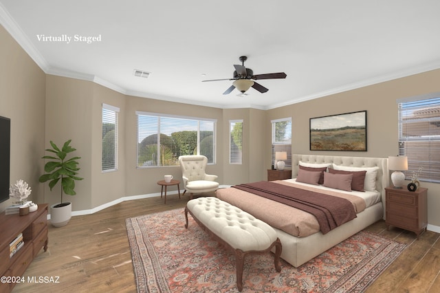 bedroom featuring crown molding, dark hardwood / wood-style floors, and ceiling fan