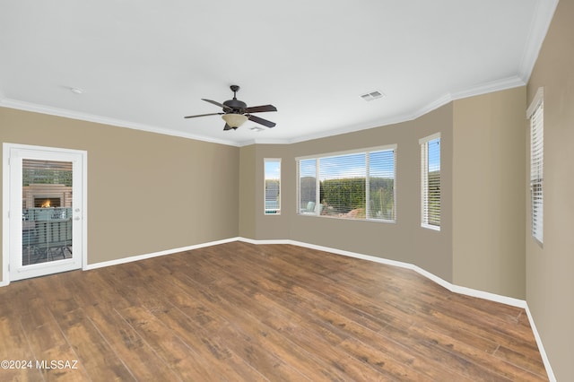 empty room featuring ceiling fan, crown molding, and hardwood / wood-style floors