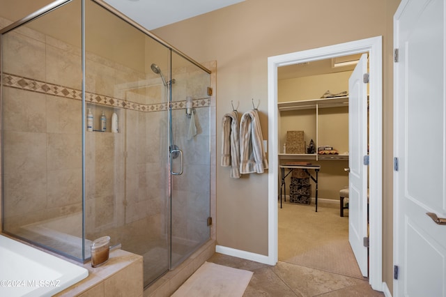 bathroom featuring a shower with door and tile patterned flooring