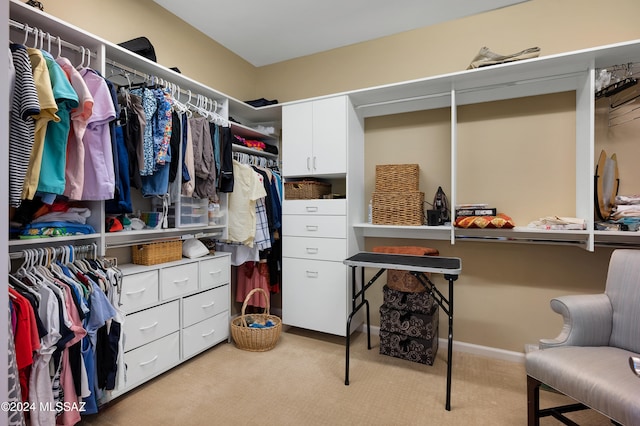 walk in closet featuring light carpet