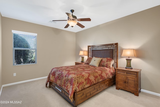 bedroom featuring light carpet and ceiling fan