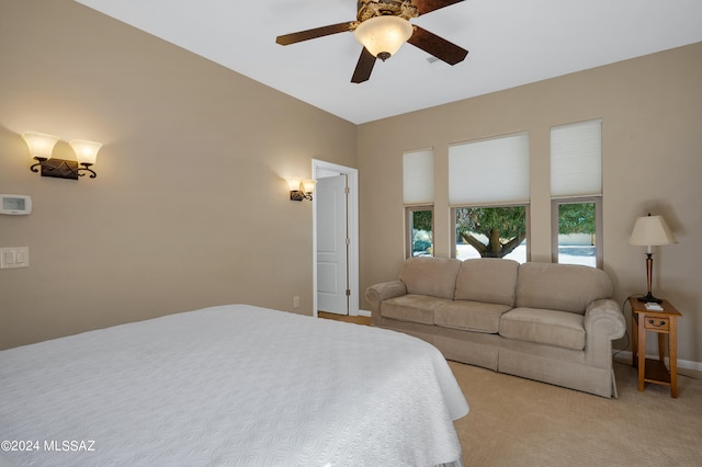 bedroom featuring light colored carpet and ceiling fan