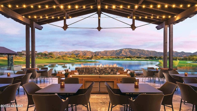 patio terrace at dusk with a water and mountain view