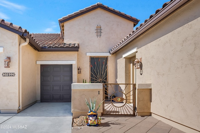 doorway to property with a garage