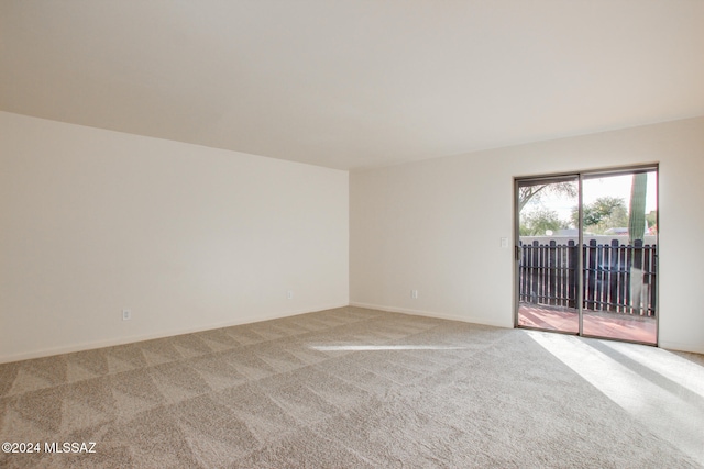 unfurnished room featuring light colored carpet