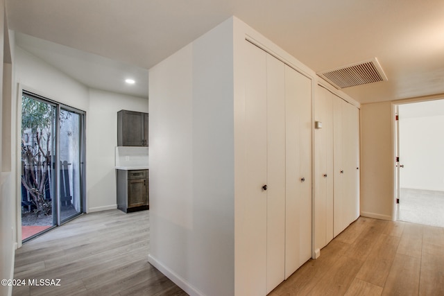 corridor with light hardwood / wood-style floors