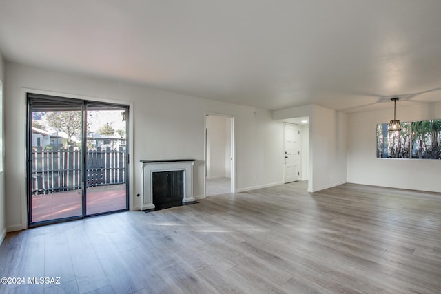 unfurnished living room with light hardwood / wood-style flooring