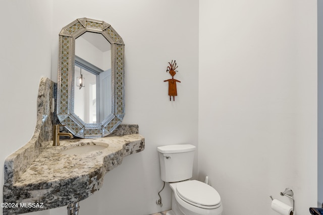 bathroom featuring toilet and sink