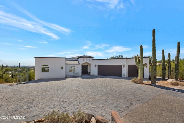 702 W Cresta Loma Dr, Tucson, AZ 85704 - view of front of home with a garage, stucco siding, and decorative driveway