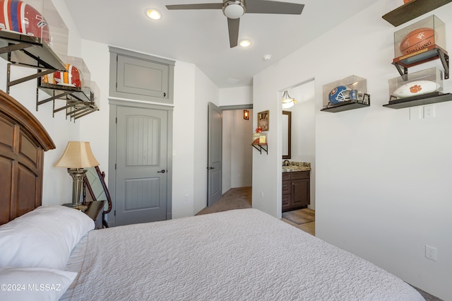 carpeted bedroom featuring ensuite bathroom and ceiling fan