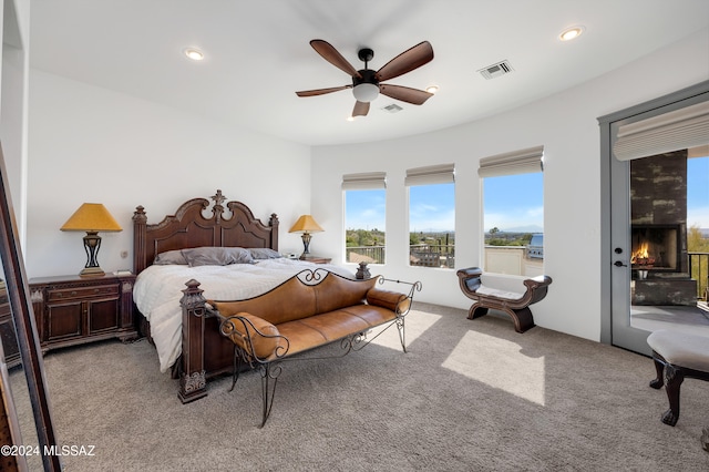 bedroom featuring access to outside, light colored carpet, and ceiling fan