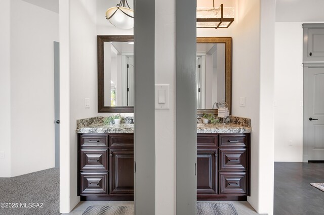 carpeted bedroom with ceiling fan and ensuite bathroom