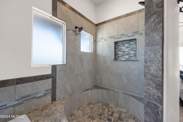 bathroom featuring a healthy amount of sunlight and tiled shower