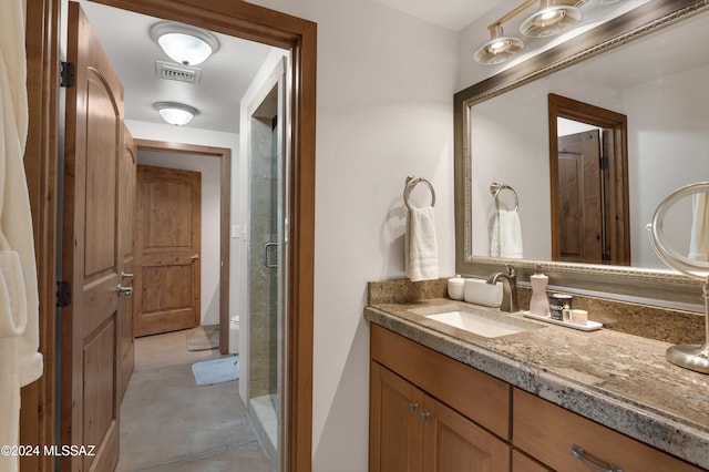 bathroom featuring vanity and an enclosed shower