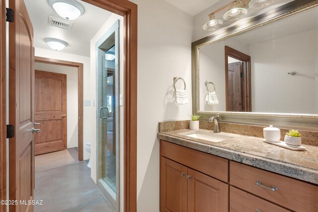 bathroom featuring vanity and toilet