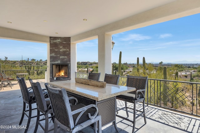 view of patio featuring a mountain view and a large fireplace