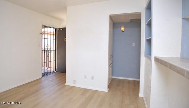 empty room with light hardwood / wood-style floors