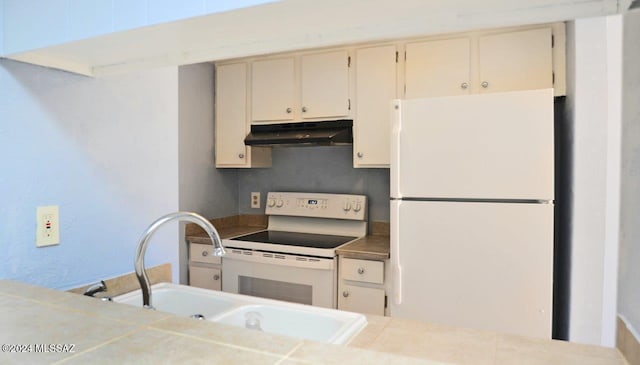 kitchen with sink, cream cabinetry, white appliances, and tasteful backsplash