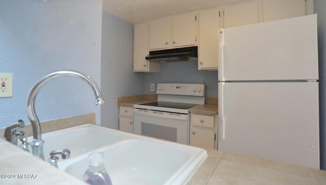 kitchen featuring tile patterned flooring, tile countertops, sink, a textured ceiling, and white appliances