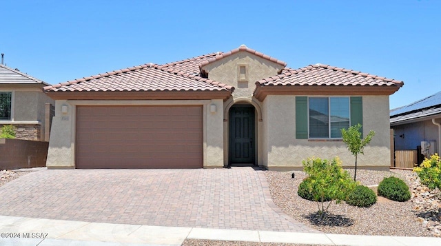 mediterranean / spanish house featuring a garage