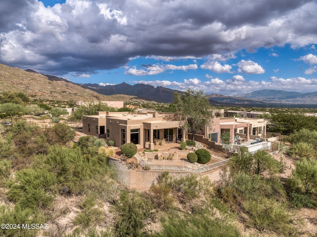 rear view of house featuring a mountain view