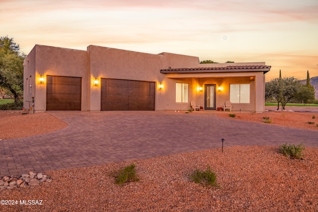 pueblo-style home with a garage