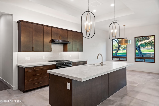 kitchen with high end stove, sink, an island with sink, and dark brown cabinets