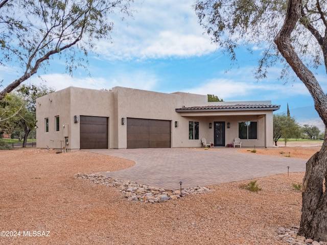 pueblo-style house with a garage