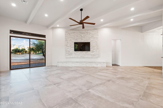 unfurnished living room with beam ceiling, a fireplace, and ceiling fan