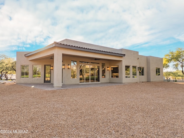 back of house with a patio area and ceiling fan