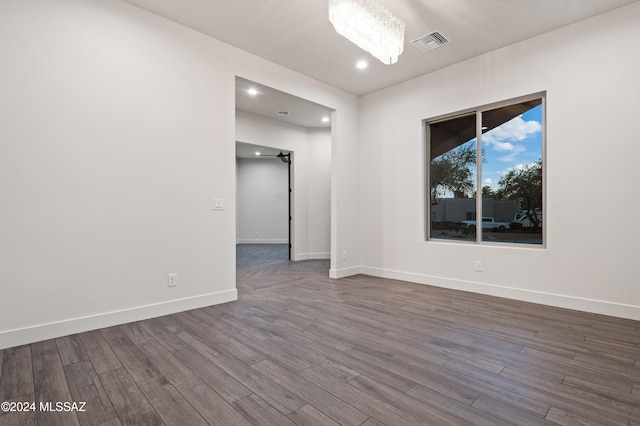 spare room featuring dark wood-type flooring