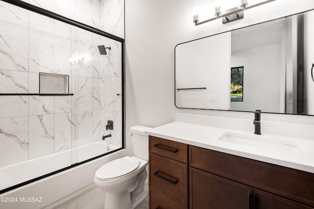 full bathroom with bath / shower combo with glass door, vanity, and toilet