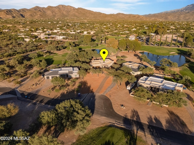 birds eye view of property with a water and mountain view