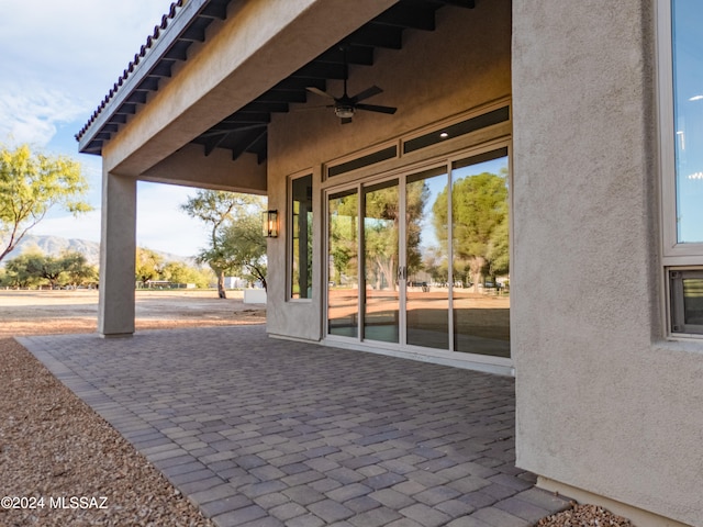 view of patio with a mountain view and ceiling fan