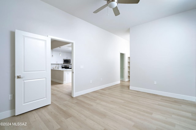 empty room with light wood-type flooring and ceiling fan