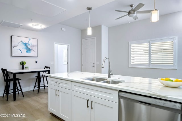 kitchen with light hardwood / wood-style floors, white cabinetry, sink, light stone counters, and stainless steel dishwasher